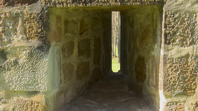 Narrow vertical viewing slit in old castle stone wall loophole fortress loophole