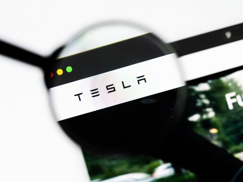 Milan, Italy 2026, 20 Apr Closeup of Tesla website on a laptop screen. Tesla logo under a magnifying glass.