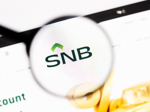 Milan, Italy 2026, 20 Apr Closeup of The Saudi National Bank SNB website on a laptop screen. The Saudi National Bank SNB logo under a magnifying glass.