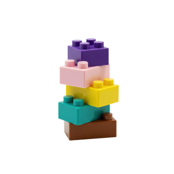 A collection of five colorful interlocking plastic building blocks in purple, pink, yellow, teal, and brown on a white background with a playful childhood theme