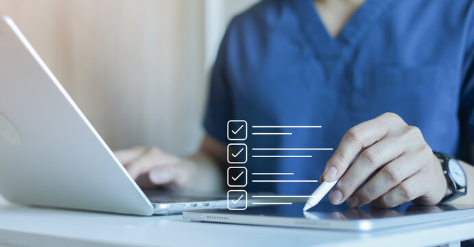 close up young general practitioner hand use stylus pen to check box on medical checklist or opd record to read and diagnose and assess about patient's symptom for healthy and lifestyle concept