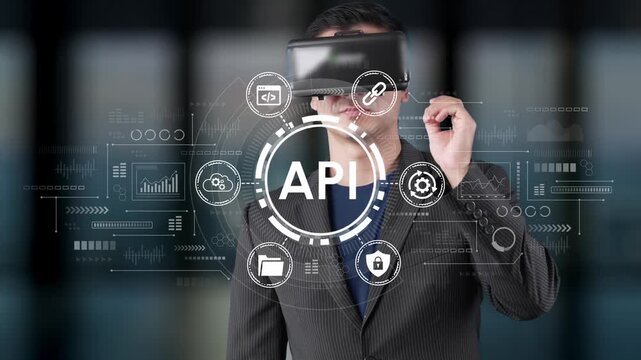 Businessman Using Virtual Reality Technology with API Icons and Digital Interface Overlays Representing Innovation and Connectivity in Modern Workplace. Entropy.