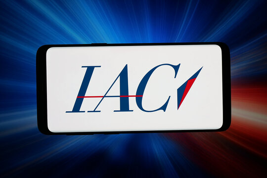 Stuttgart, Germany - 06-05-2026: In this photo illustration, the logo of US media holding company IAC Inc. is displayed on a smartphone in front of abstract background on computer screen.