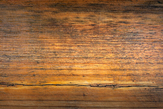 Close-up view of a wooden surface showing grain and texture in natural light during the day