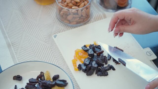 Top view of slicing dried apricots and prunes for traditional Armenian dish