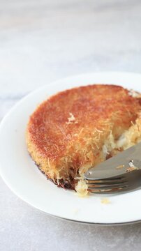 traditional Turkish kunefe dessert with melting cheese and pistachio on a plate