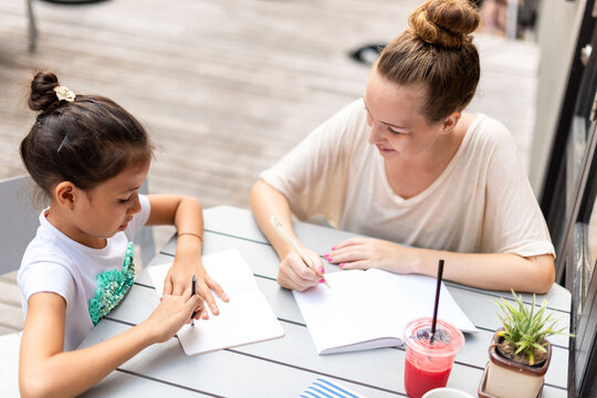 Mother daughter bonding over writing.