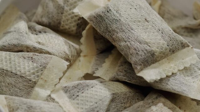 Snus nicotine tobacco close up, pack of tobacco for gum. unhealthy addiction. Man opening box with snus and taking one.