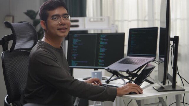 Focused Developer Working on Multiple Screens Displaying Code in a Remote Environment