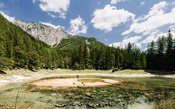 Gruner See in Austria with forest and mountains reflected in the water, emphasizing eco tourism awareness of environmental change