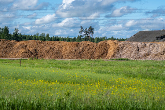 Wood Chip Biomass Storage Piles at Agricultural Processing Site and Rural Landscape