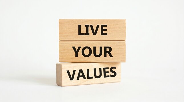 Wooden blocks spell live your values on a white surface with ample copy space.