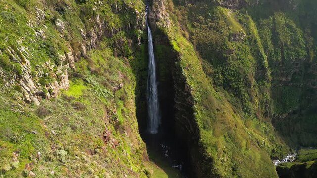 Cinematic Drone Shot of High Waterfall on Steep Mountin Cliff
