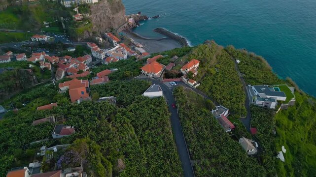 Cinematic Aerial View of Luxury Coastal Village and Huses on Green Slopes