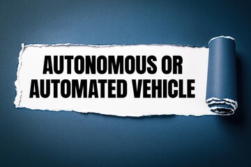 Fototapeta premium autonomous or automated vehicle text revealed under torn dark blue paper