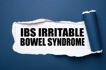 Naklejka premium ibs irritable bowel syndrome written under a torn blue paper