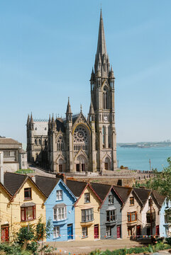 St Colman's Cathedral rising above colorful houses in Cobh County Cork Ireland