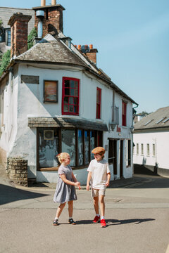 Children holding hands while exploring a charming Irish village