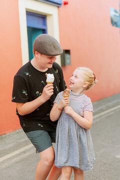 Brother and sister enjoying ice cream together on vacation