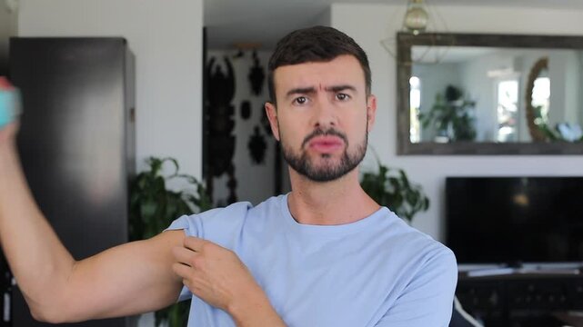 Skinny Man Flexing Biceps With Small Plastic Weight