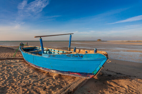 Authentic arabic old wooden boat on the coast of a scenic tropical lagoon in Marsa Alam region, Red Sea.