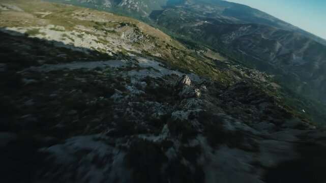 Cinematic FPV Drone Shot Racing Over Rugged Mountain eak Ridge