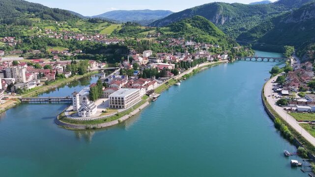 Wide aerial panorama of Andricgrad and the Drina River waterfront in Visegrad