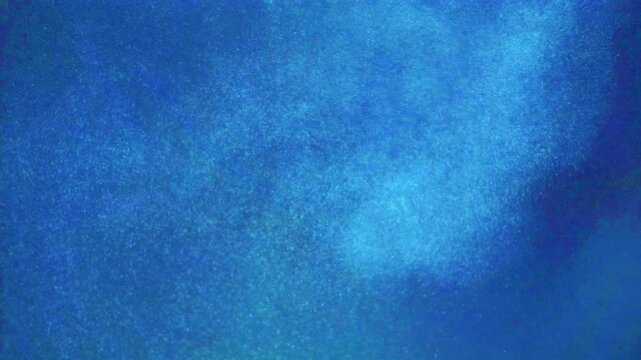 Abstract underwater background featuring swirling blue bubbles in deep water.