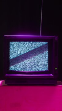 Retro TV, vintage television In a nostalgic setup, a retro TV displays grain on screen, scary halloween night device good for chroma key and green screen