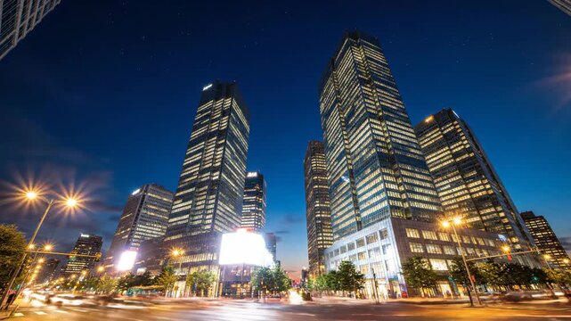Dynamic time-lapse captures a modern city's transition from vibrant sunset to star-filled night. Skyscrapers illuminate, and busy street traffic creates light trails.