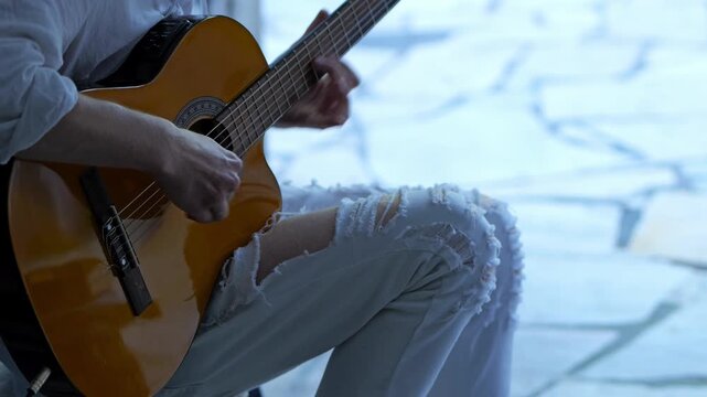 Street musician playing acoustic guitar solo