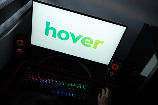 Punta Arenas, Chile &ndash; June 12, 2026: A desktop PC monitor showing the Hover internet services branding on a white background, surrounded by an illuminated gaming keyboard and peripherals