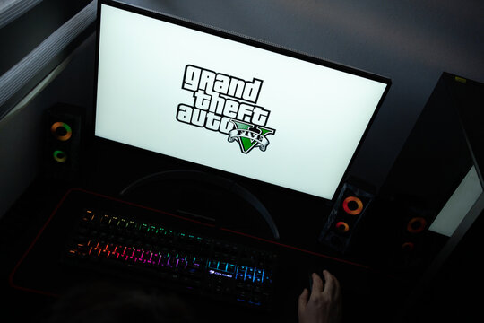 Punta Arenas, Chile &ndash; June 12, 2026: A desktop PC monitor showing the Rockstar Games GTA 5 branding on a white background, surrounded by an illuminated gaming keyboard and peripherals