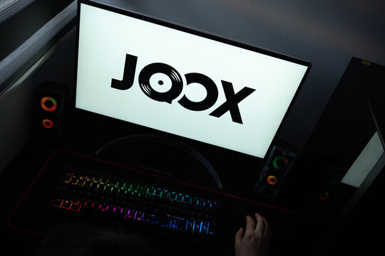 Punta Arenas, Chile &ndash; June 12, 2026: The official Joox music streaming service logo with a vinyl record icon displayed on a computer screen in a dark room workspace setup