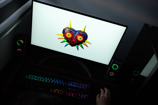 Punta Arenas, Chile &ndash; June 12, 2026: A desktop PC monitor showing Nintendo's iconic Majora's Mask symbol on a white background, surrounded by an illuminated gaming keyboard and peripherals