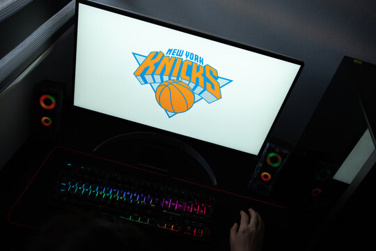 Punta Arenas, Chile &ndash; June 17, 2026: The official orange, blue, and silver typographic logo of the New York Knicks basketball team displayed on a computer screen in a dark room workspace setup