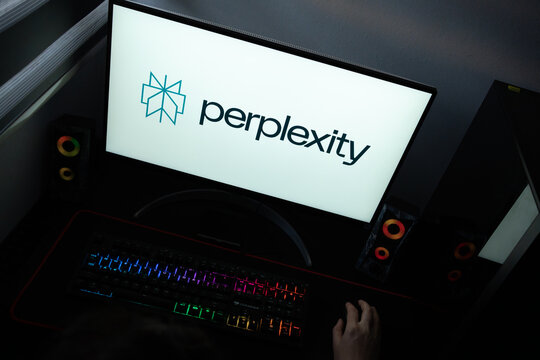 Punta Arenas, Chile &ndash; June 17, 2026: The official teal geometric asterisk emblem and dark typographic logo of Perplexity AI displayed on a computer screen in a dark room workspace setup