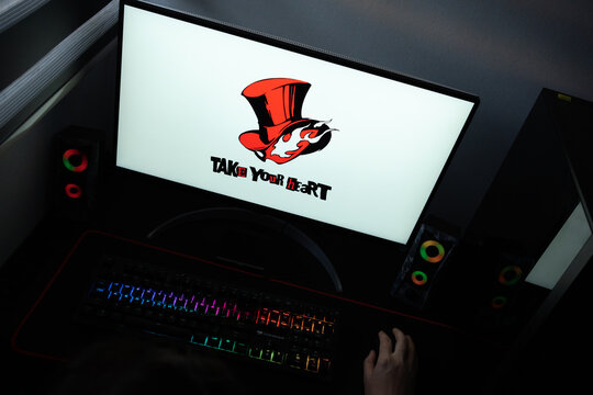 Punta Arenas, Chile &ndash; June 17, 2026: The official "Take Your Heart" Phantom Thieves of Hearts logo from the Persona 5 video game series displayed on a computer screen in a dark room workspace setup
