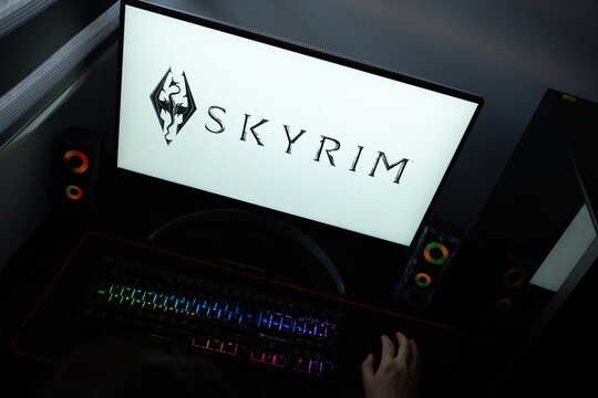 Punta Arenas, Chile &ndash; June 17, 2026: A desktop PC monitor showing the Bethesda Skyrim game branding on a white background, surrounded by an illuminated gaming keyboard and peripherals