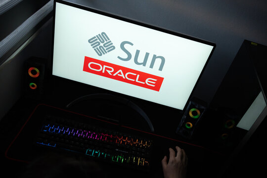 Punta Arenas, Chile &ndash; June 17, 2026: The official Sun Microsystems diamond logo alongside the red Oracle corporate branding displayed on a computer screen in a dark room workspace setup