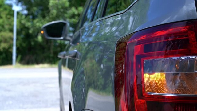 Rear car lights flash red, signaling an emergency stop and alerting other drivers to maintain safe distance on the road. Driving safety manuals, hazard light tutorials, emergency response guides