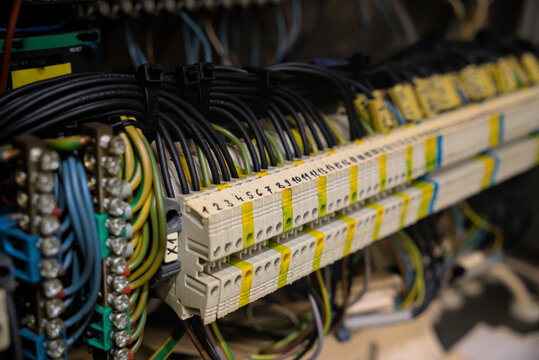 Close-up of industrial electrical terminal block with numbered wire connections in control cabinet
