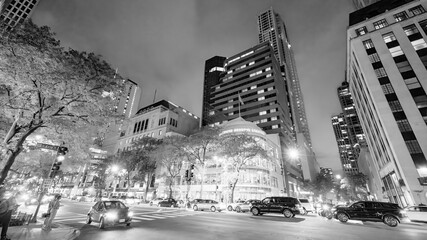 Fototapeta premium Chicago, IL - July 27, 2024: Skyscrapers at night along Magnificent Mile