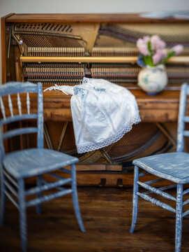 Rustic Interior with Vintage Upright Piano, Blue Chair and Pink Hyacinths
