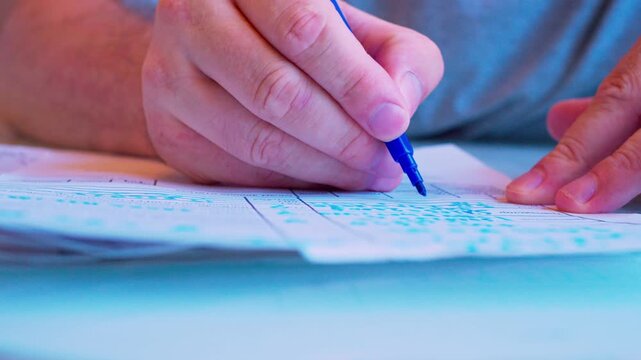 Cinematic macro of a hand filling a survey or job application form. Defocused background, soft window light. Visualizes questionnaire, voting, human resources hiring process and research.