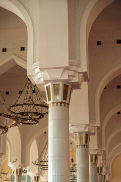 An interior shot of an architectural space with ornate white columns and arches.