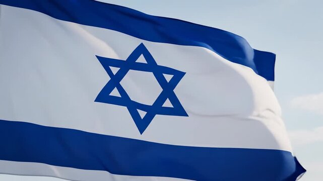 Tracking video from left to right of israeli flag waving in closeup against pale blue sky, national identity concept