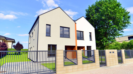 Fototapeta premium Newly constructed semi detached house for families. Modern design, technology, and real estate market concept.