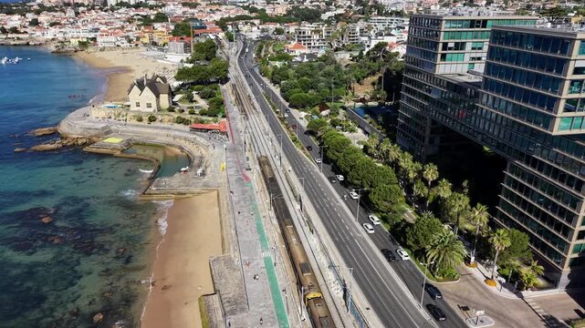 Aerial drone view over modern hotel luxury apartments and Avenida Marginal coastal road in Cascais Portugal
