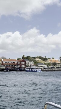 Public water taxi navigating the water channel in Willemstad, Curacao, during pontoon bridge closure.